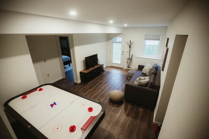 The downstairs living room has a pull-out sofa bed, a large air hockey table, and a Wii system with tons of games