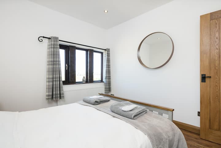Bedroom 1 - double bed with walk-in wardrobe and ample drawer storage.