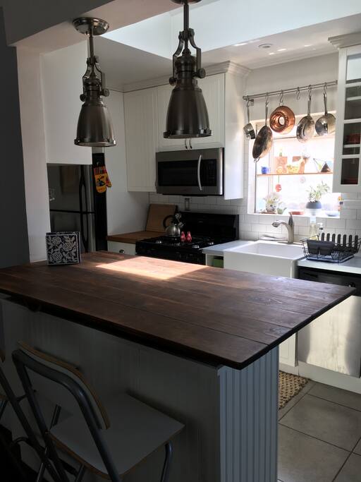 Kitchen with tons of amenities - oven, stove, coffee beans, grinder & Aeropress, microwave, stand mixer, blender, food processor, toaster oven, ice maker, pots and pans.