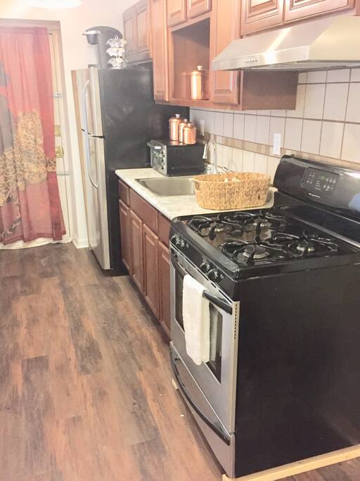 New full kitchen with stainless steel appliances.