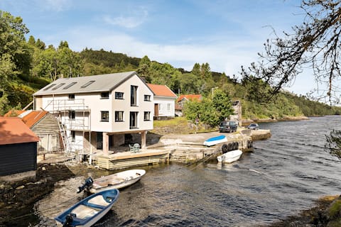 Renovated smokehouse with character, by the water's edge.