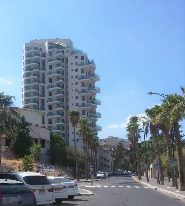External view at the building. Small shops for basic needs very close. The apartment has its own parking place in the basement. Gate is open with the remote control.