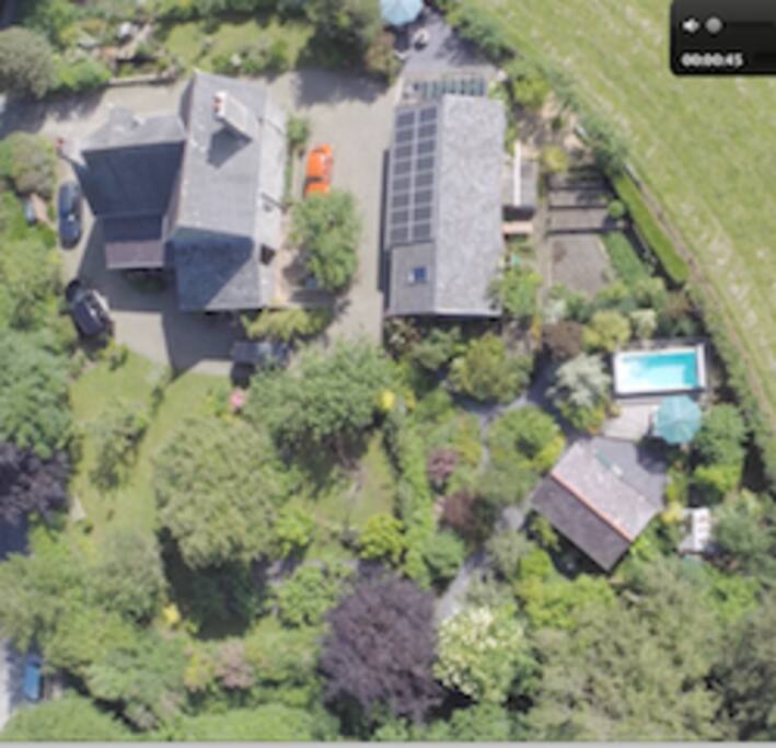 Ty Haf and swim spa in the corner of the garden overlooking fields