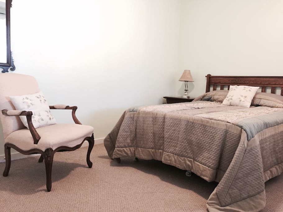 Spacious bedroom with double bed, large closet, dresser and night stand.