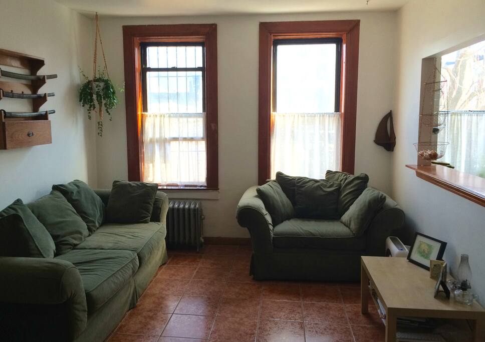Living room with super-comfy couches, with a cut-out window into the kitchen.