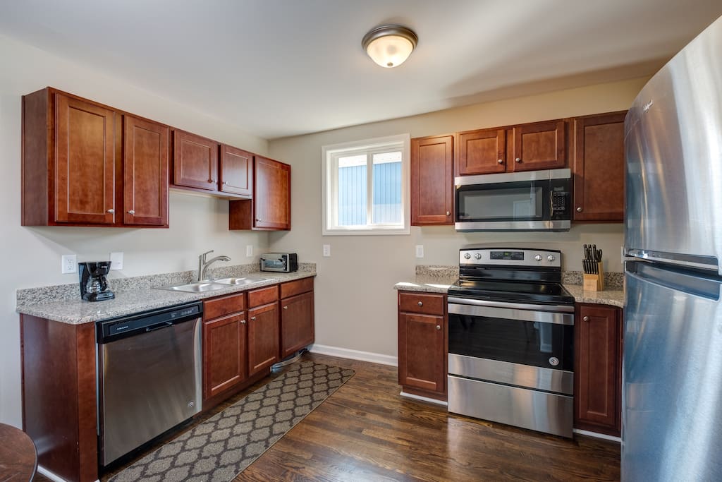 Spacious kitchen is stocked with a starter supply of dish soap and paper towels.