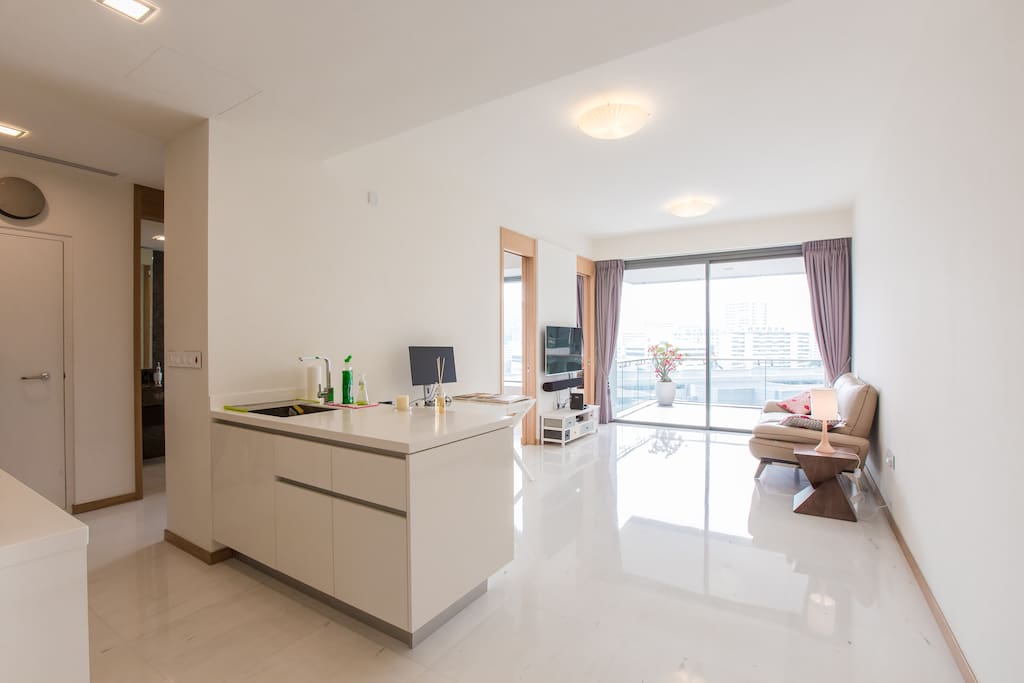 A Spacious Living with new modern furniture and access to large balcony overlooking the pool