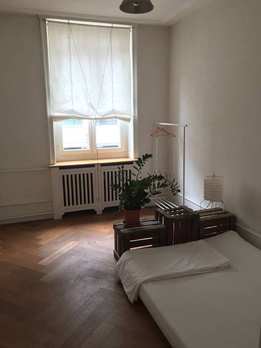 Bedroom has lovely wooden floor, high ceiling