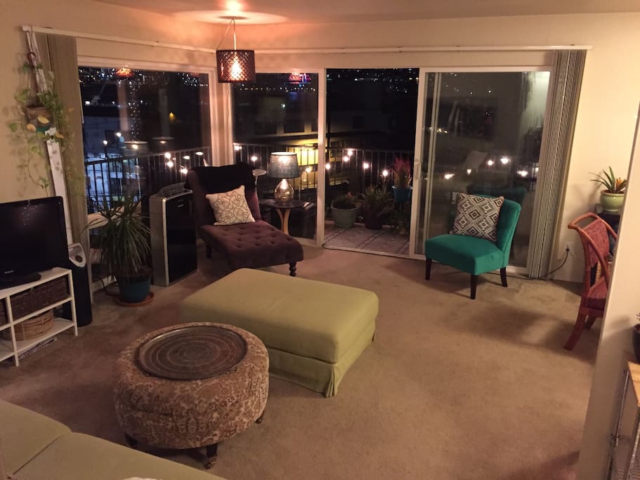 Living room. Comfortable seating for 5+ ppl. Floor to ceiling Windows and breathtaking view of the Seattle city skyline.