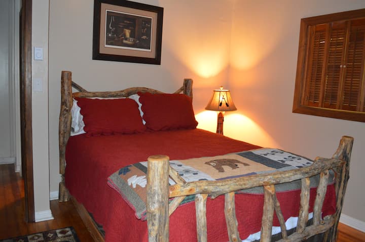 Queen solid log bed with nightstand, dresser, and closet.