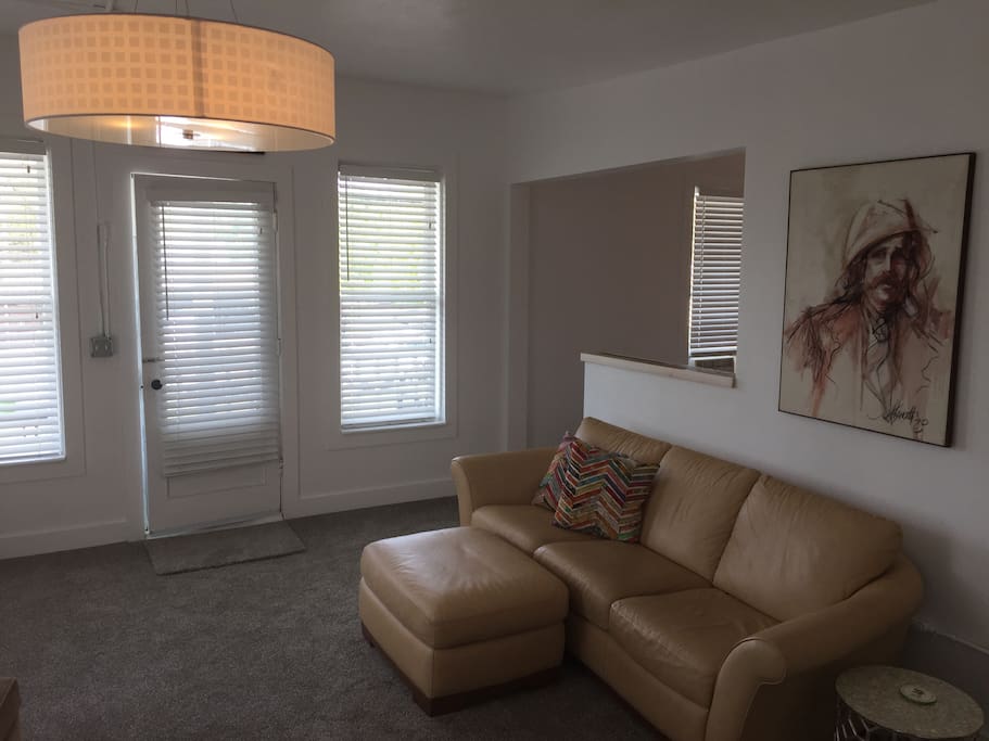 Spacious living room with Flat screen tv, Dish Satellite and an entrance to a private balcony.