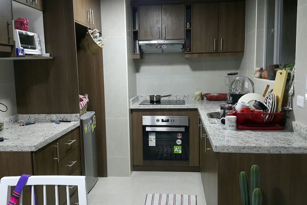 kitchen with electirc stove and oven, electric kettle, blender, french coffee maker.