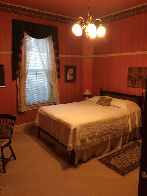 Room with antique bed, dresser & desk plus small sofa