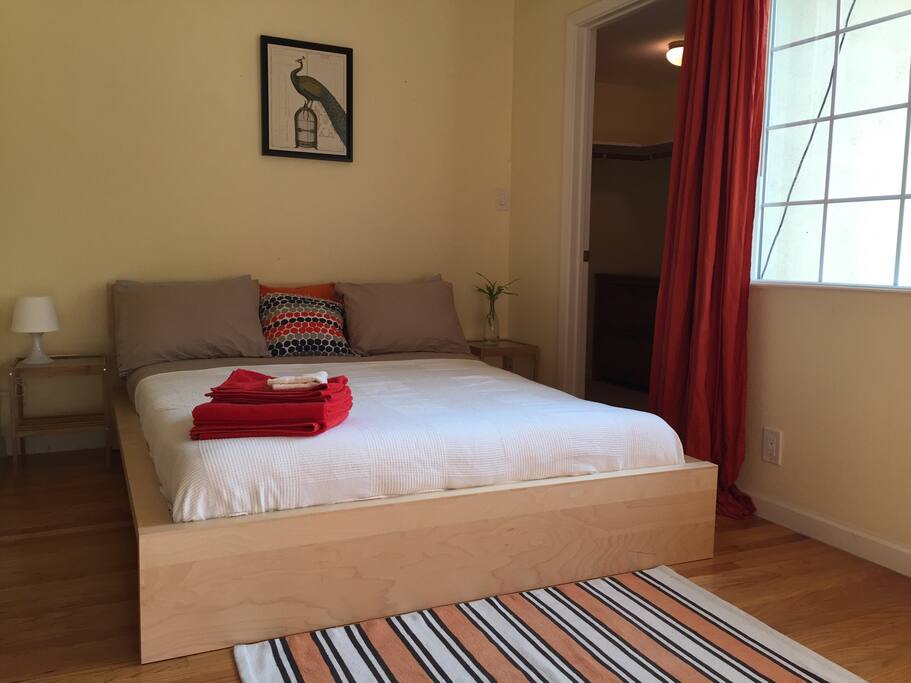 Queen bed with freshly washed bed sheets and towels for each guest.