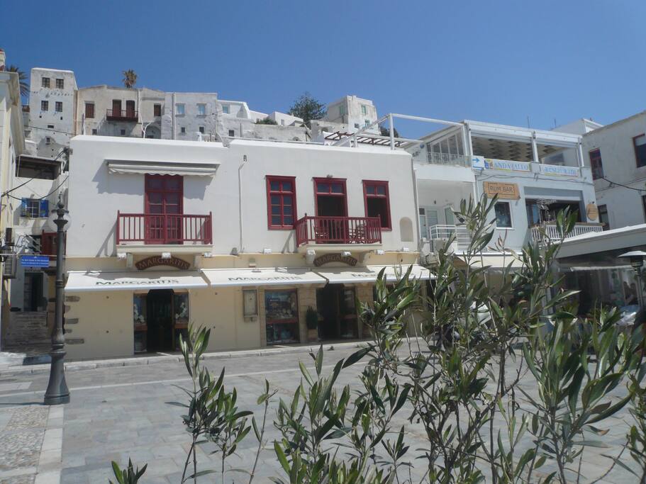 The house is the one on the right side with the balcony and the windows.