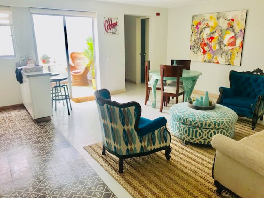 View of the living room, dinning area and bar of the kitchen