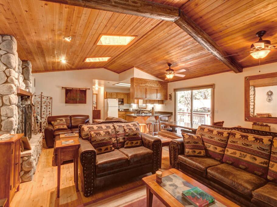 Spacious open living area with wood burning romantic fireplace, comfy sofa and LCD TV and WiFi.