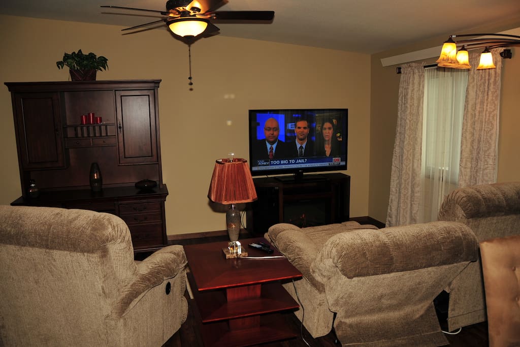What a way to relax...reclining Lazy Boy sofa and oversized chair in front of a 60" TV.