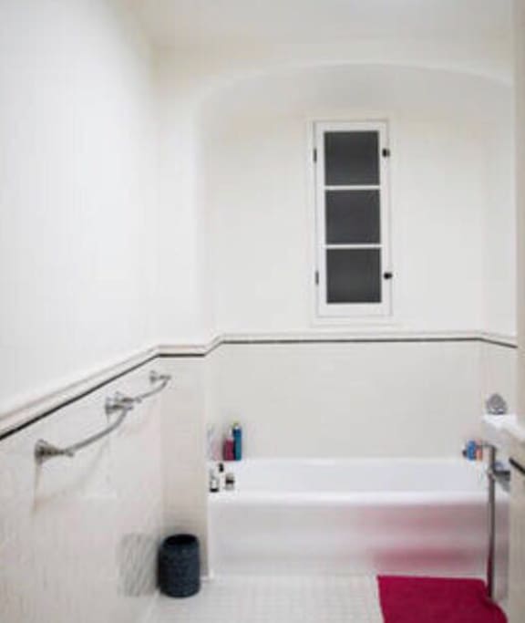 bathroom with a bathtub and a shower