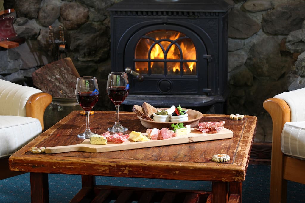 Enjoy a glass of wine next to the fireplace in our guest lounge