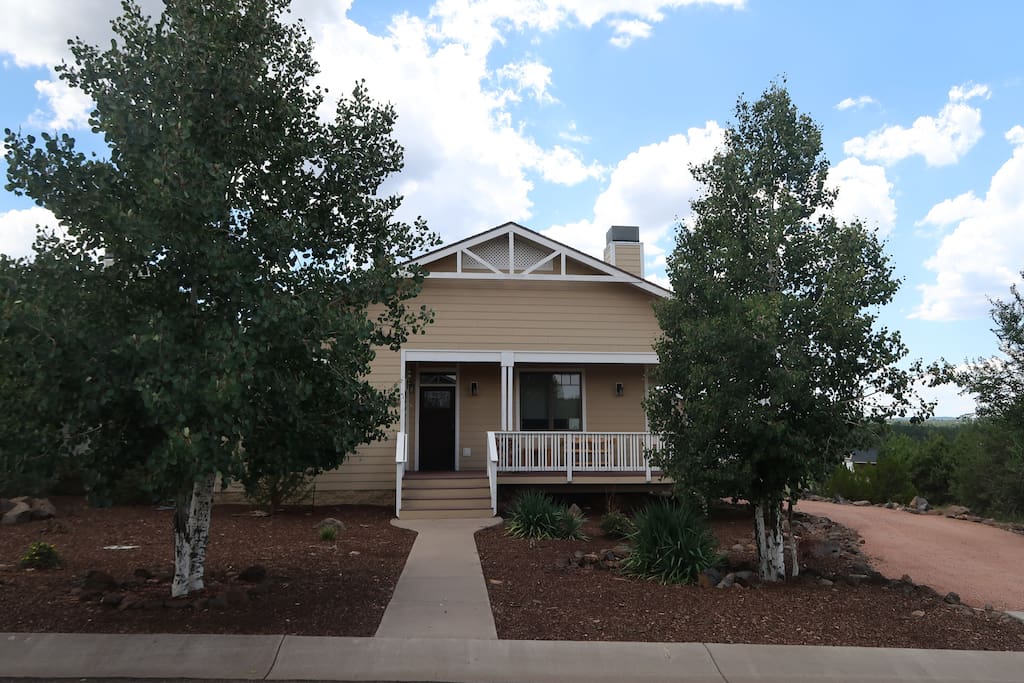 The cottage is the perfect getaway for a quaint, small town getaway. Aspen trees frame the front of the house.