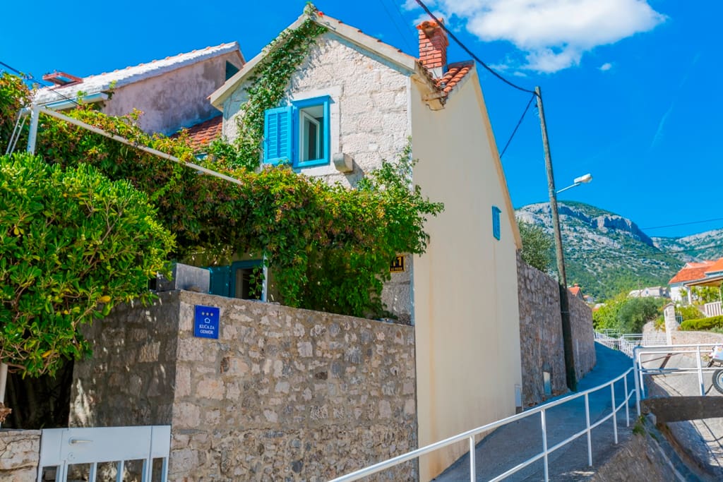 Two-storey rustic stone house hides behind the walls a piece of paradise.