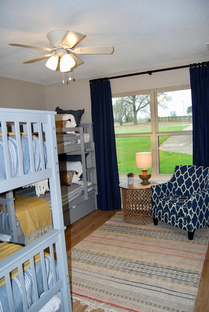 Bunk room view from doorway. Includes 4 beds and 1 trundle bed and 2 large closets.