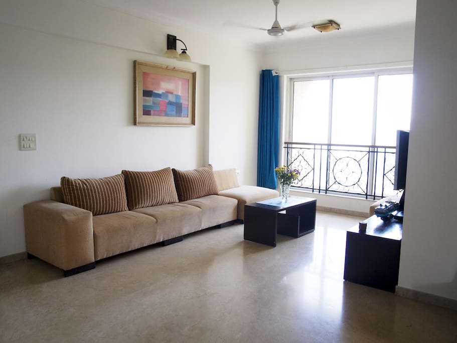 Living room overlooking a hill with greenery