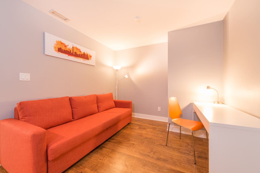 Large size den with pull out couch and table for reading or laptop