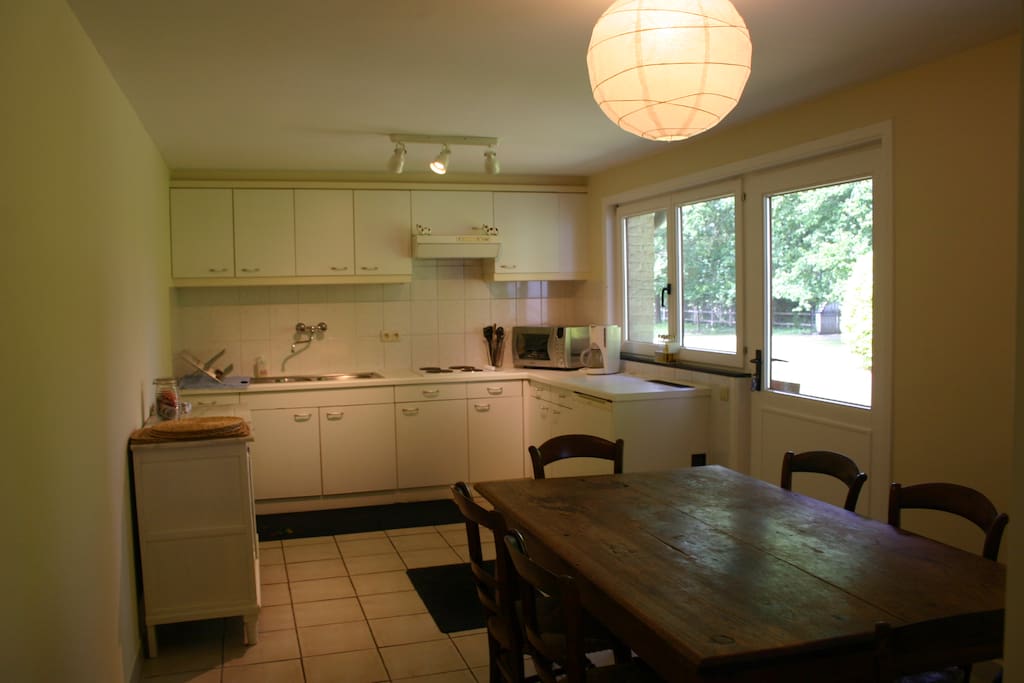 Fully equipped kitchen with door to the front garden.
