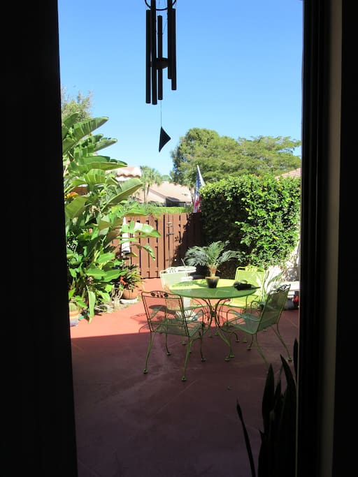 Courtyard view from guestroom through ceiling to floor slider.