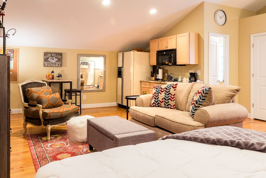 Notice the kitchenette and table with stools