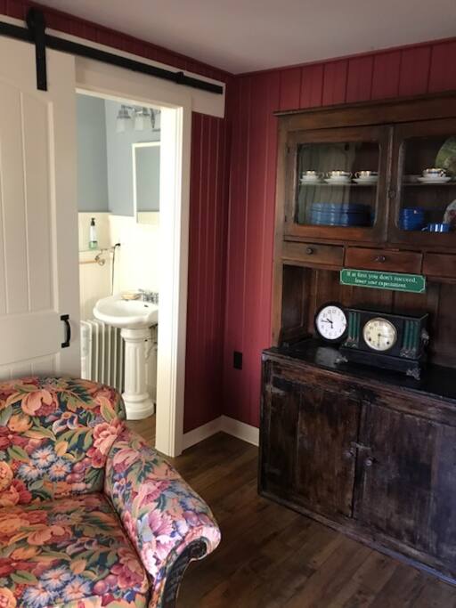 Cozy sitting room with sliding barn door to freshly remodeled bathroom.