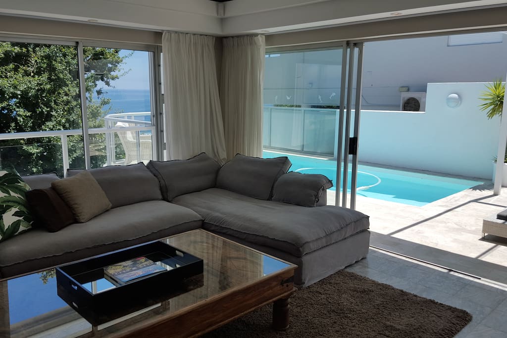 Lounge with large pool deck and barbeque area outside with 8 seater outdoor table!