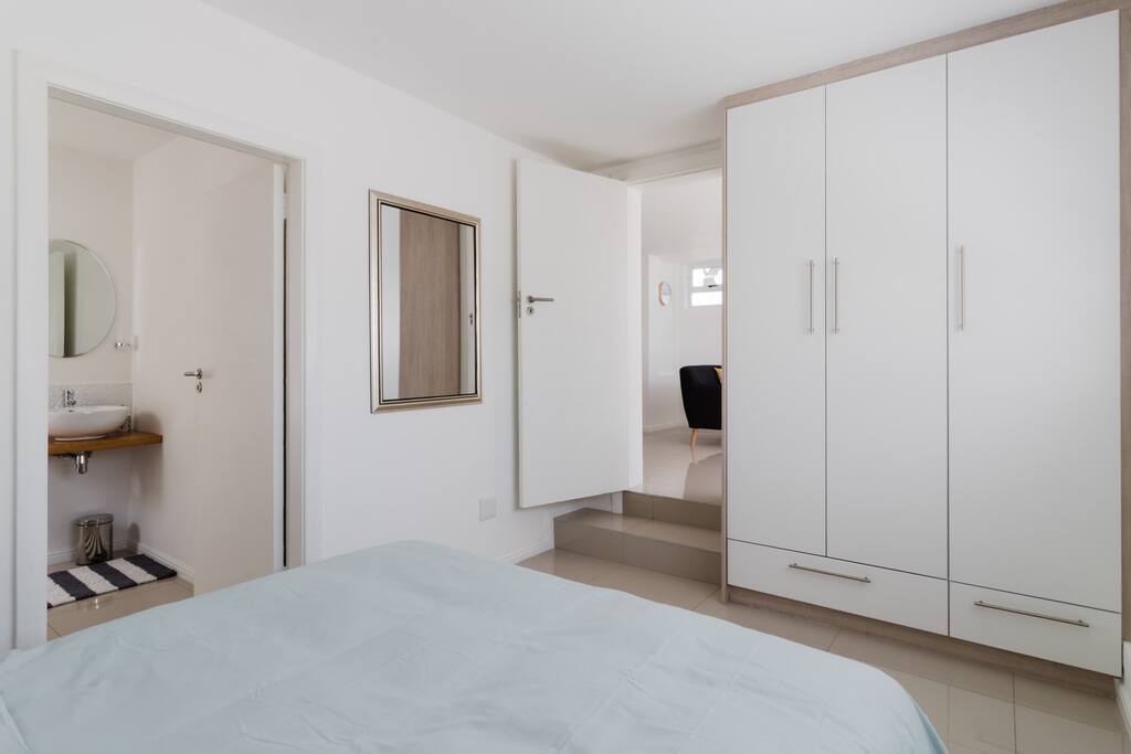 Bedroom with built-in cupboards and en-suite bathroom