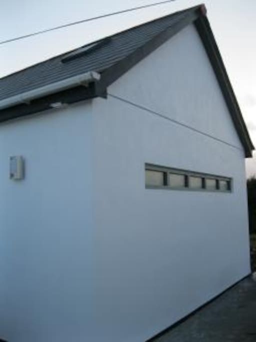 Modern and bespoke window adds light to open plan living area.