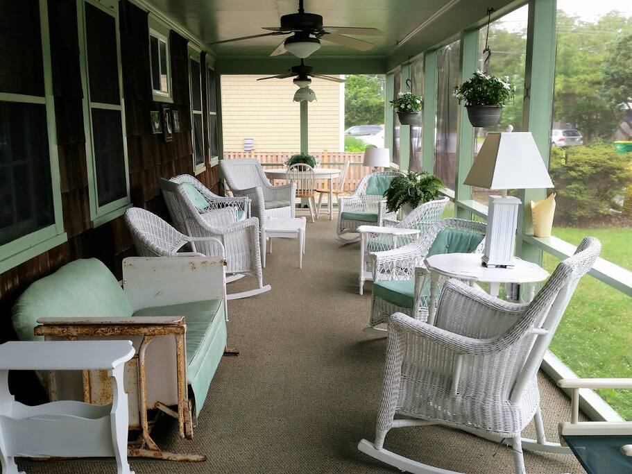 Huge wraparound screened porch where you may relax, read, nap, play games, or enjoy a cocktail