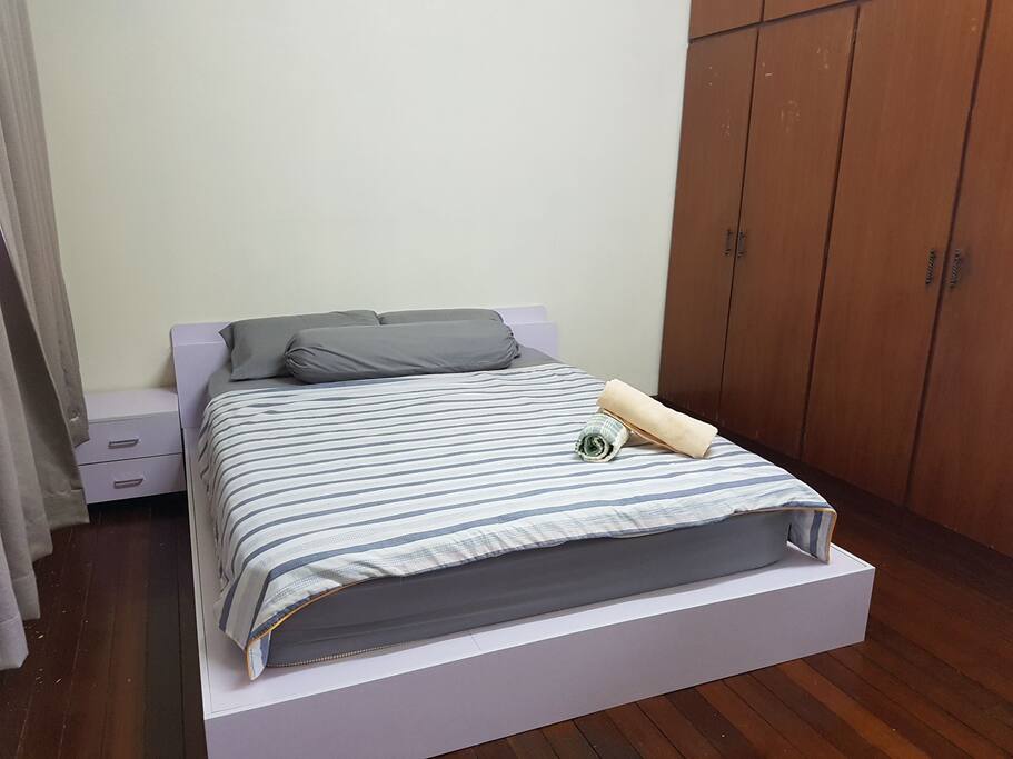 Master bedroom with queen size bed and bedside cabinet. Wardrobe includes hanger and additional blanket.