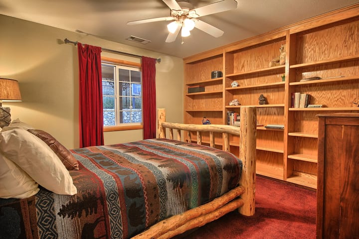 Bedroom with a plush queen bed, adorned with beautiful wool blankets for added warmth and comfort.