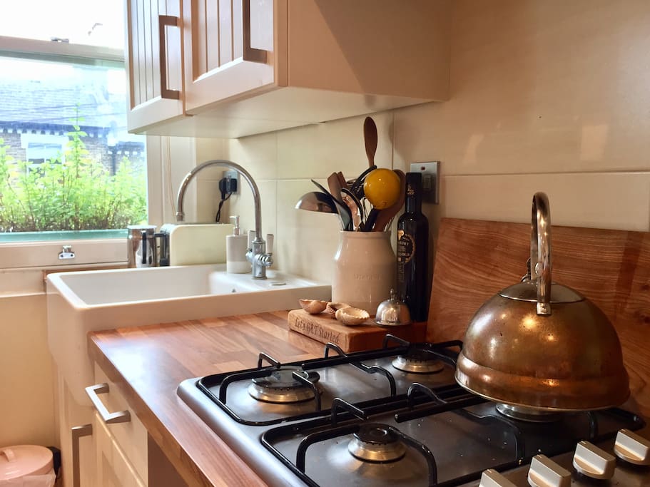 Fully equipped stylish kitchen with standalone copper kettle.
