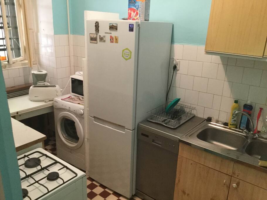The kitchen. New fridge, dishwasher and dryer. Also a stove, coffee maker, microwave, toaster, bunch of dishes and silverwalre are present.