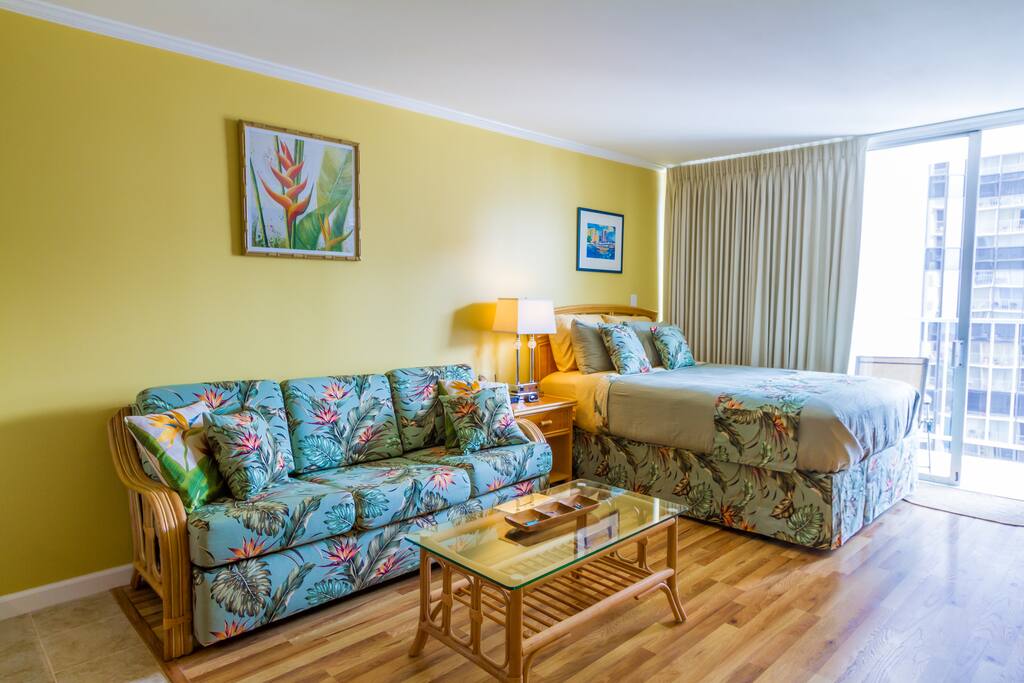 Studio - Nice sofa bed with glass coffee table and a queen size bed.