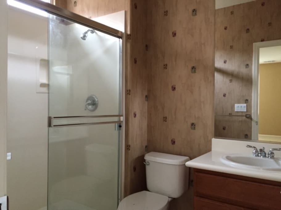 Full size bathroom with soap, shampoo and bath towels.