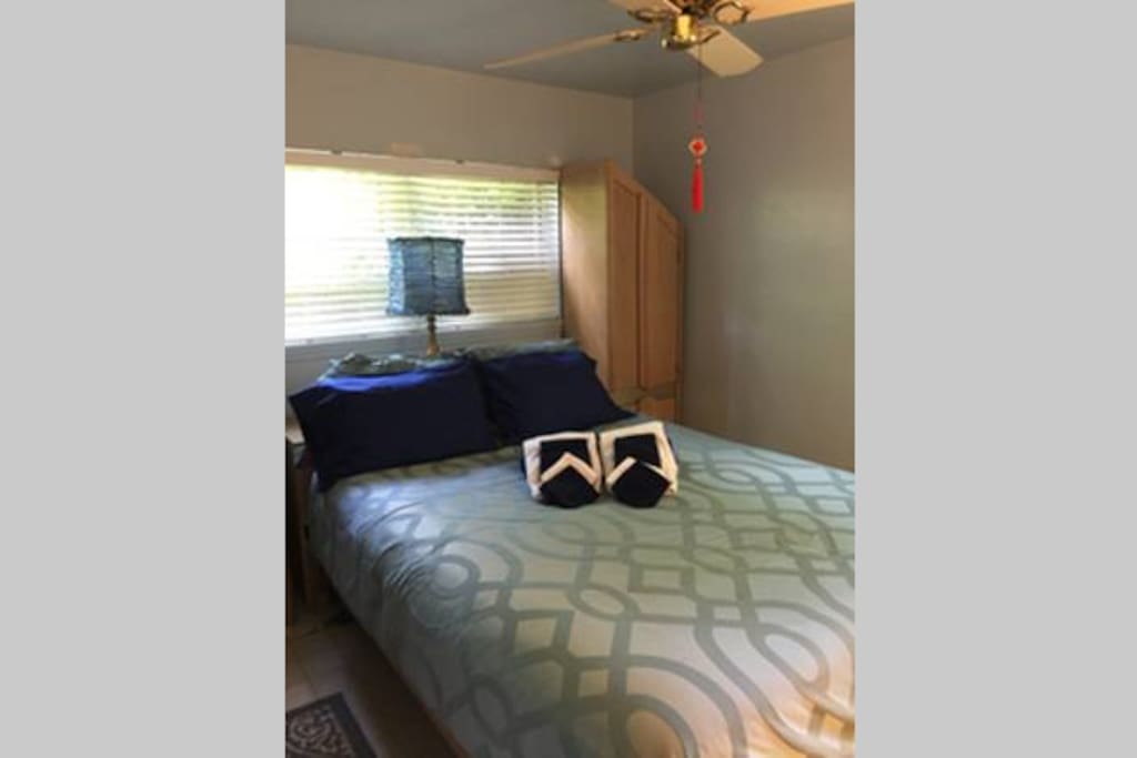 Small room space with a queen bed. (Zoë and Walsh listing)