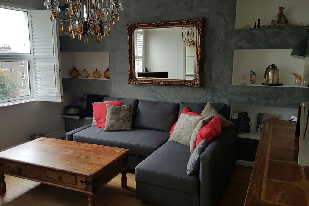 Living room from a different angle. The room overlooks the high street. Its furnished to a high standard.