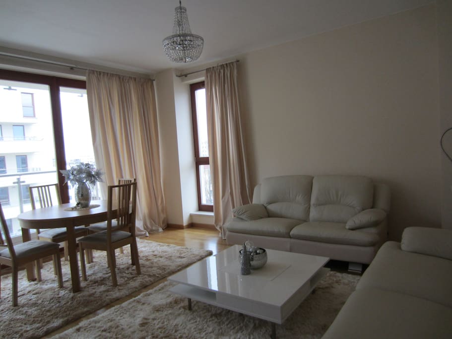 The living room with 3 and 2 seat sofas. Table with 4 chairs. TV, DVD, HI-FI
