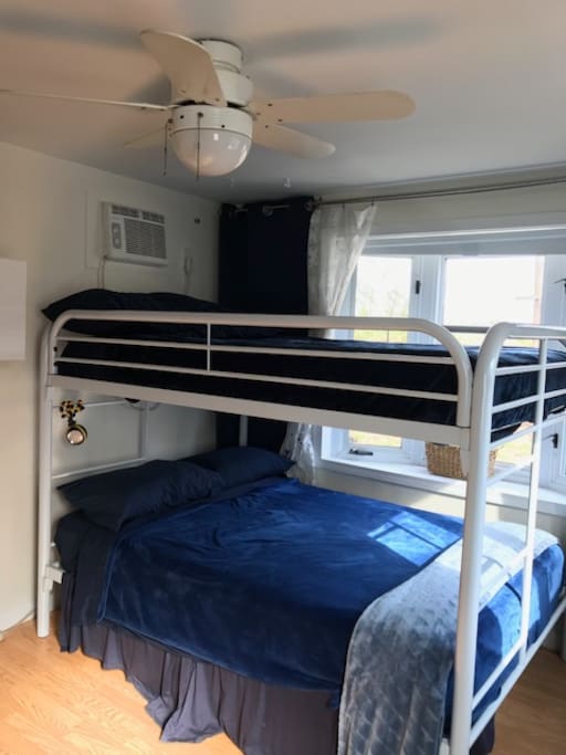 This is your Loft bed- Has 2 full size mattresses and sleeps 4 comfortably. Also room on the floor for an additional air mattress:). Your bedroom is clean, bright and Sunny with lots of amenities including dry kitchenette, hammock and fire pit right outside your door:)