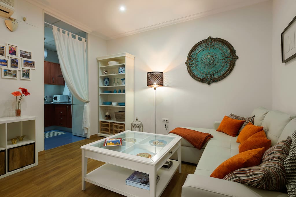 Living room with sofa, coffee table and TV.