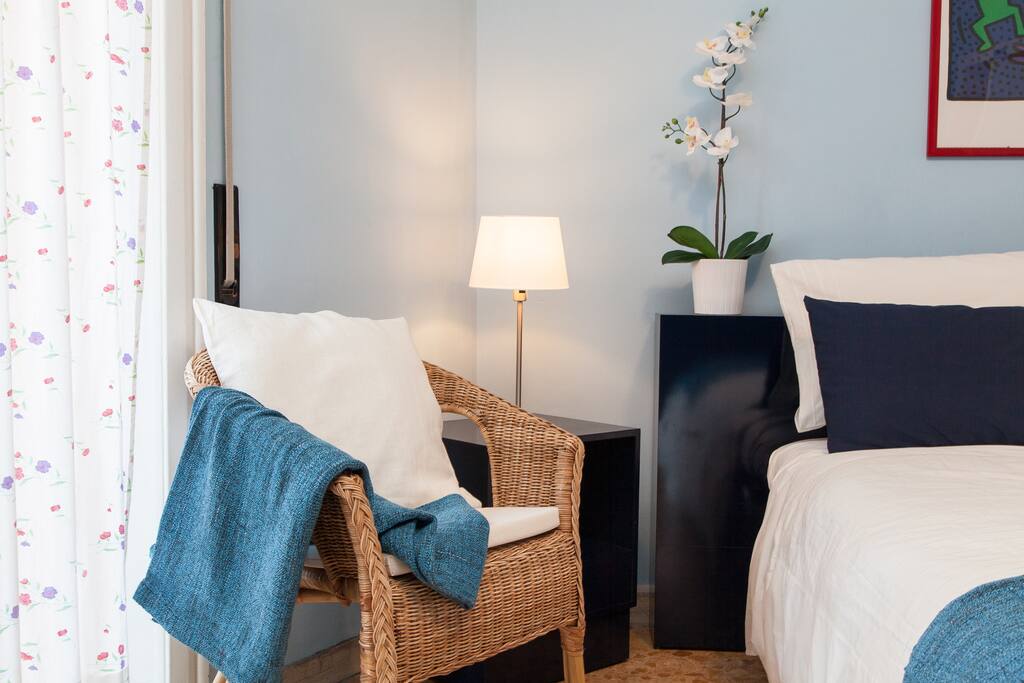 bedroom with king size bed, wardrobe, dressing table, small armchair, bedside tables, night lights