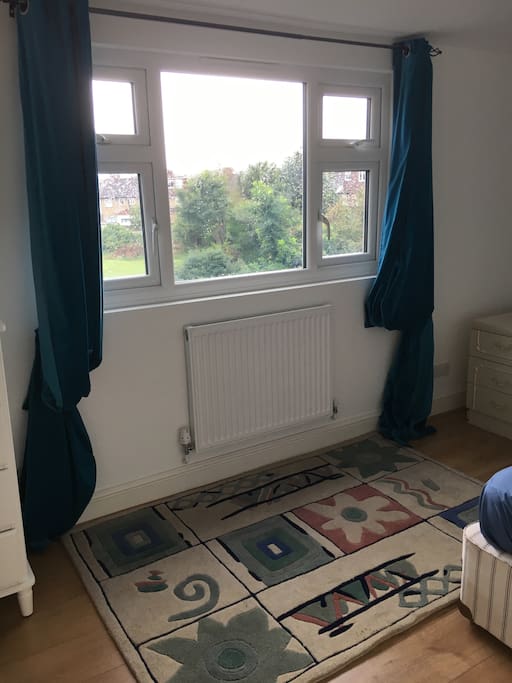 View of bedroom overlooking greenery of primary school football ground
